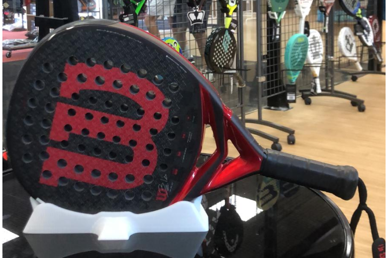 Close-up of the PalaStand desktop padel racket display stand with premium black ABS finish